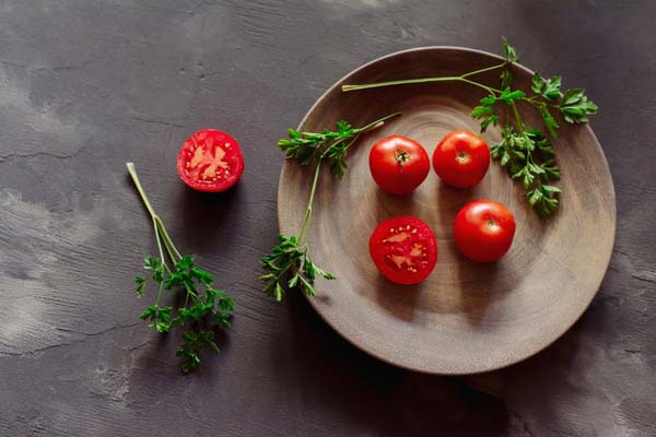 Tomatoes on a wooden plate